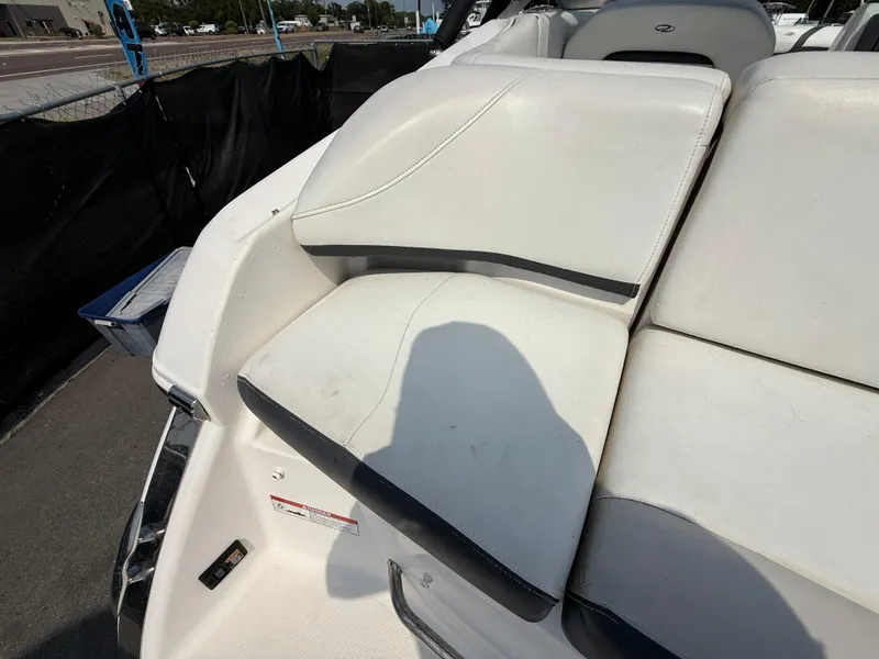 Slide: The Image of 2017 Regal 22 FasDeck boat interior with white seating and black accents. - 15