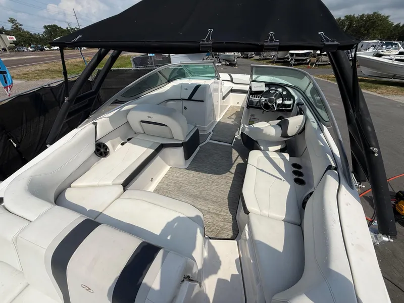 Slide: The Image of 2017 Regal 22 FasDeck boat interior with white seating and black canopy. - 21