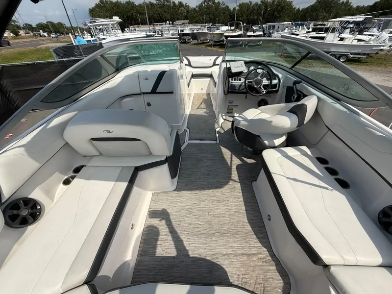 Slide: The Image of 2017 Regal 22 FasDeck boat interior with white seating and modern dashboard. - 22