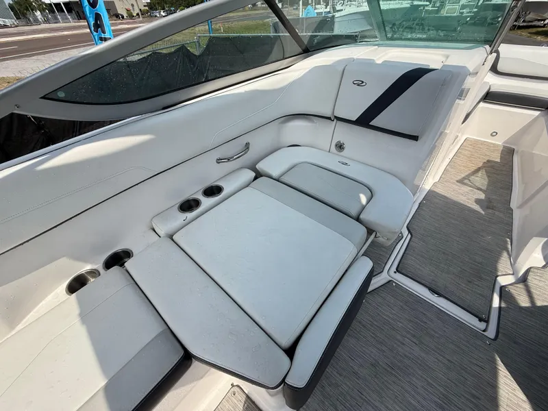 Slide: The Image of 2017 Regal 22 FasDeck boat interior with white seating and cup holders. - 25