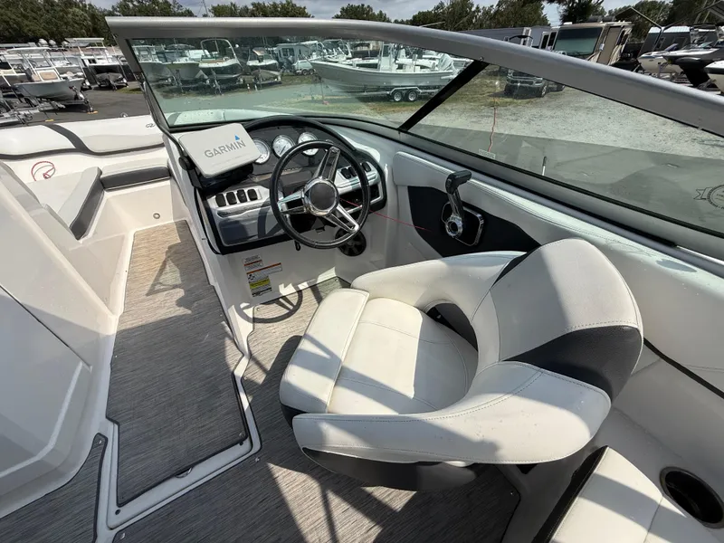 Slide: The Image of 2017 Regal 22 FasDeck boat interior with steering wheel and Garmin navigation system. - 26