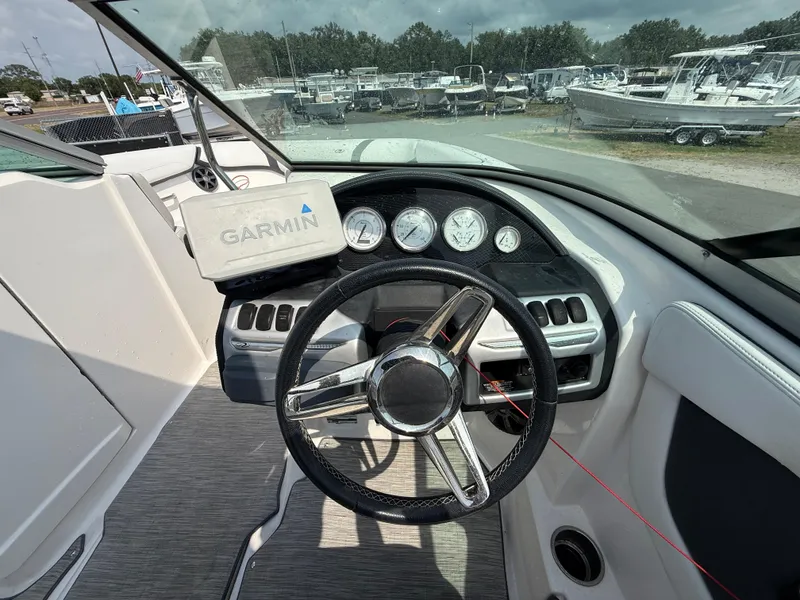 Slide: The Image of 2017 Regal 22 FasDeck boat dashboard with Garmin navigation system and steering wheel. - 27