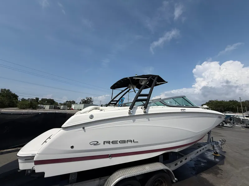 Slide: The Image of 2017 Regal 22 FasDeck boat on trailer under clear sky. - 3