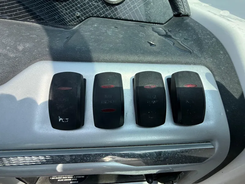 Slide: The Image of Control panel of a 2017 Regal 22 FasDeck boat with four switches. - 32