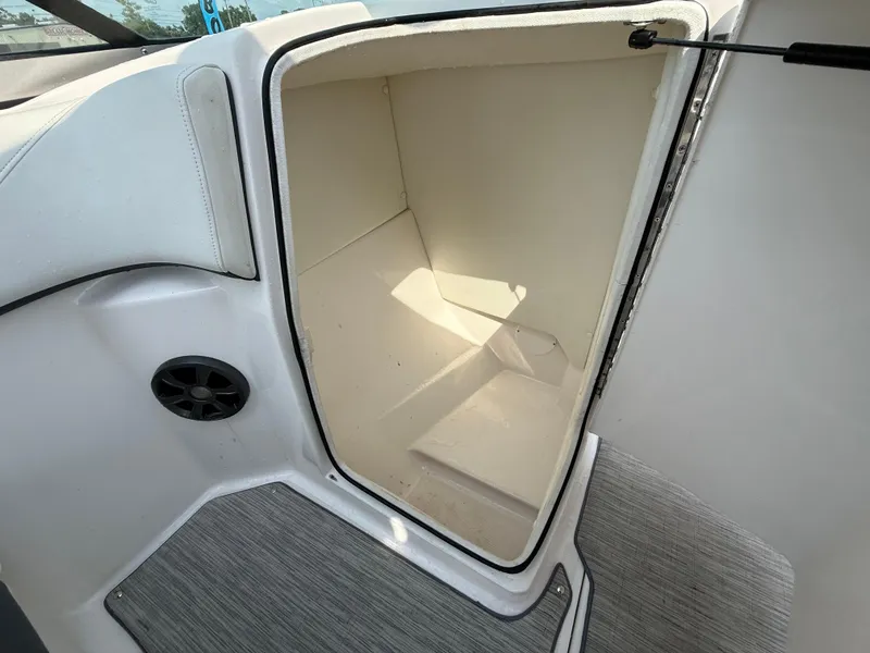 Slide: The Image of 2017 Regal 22 FasDeck boat storage compartment with open door and speaker. - 37