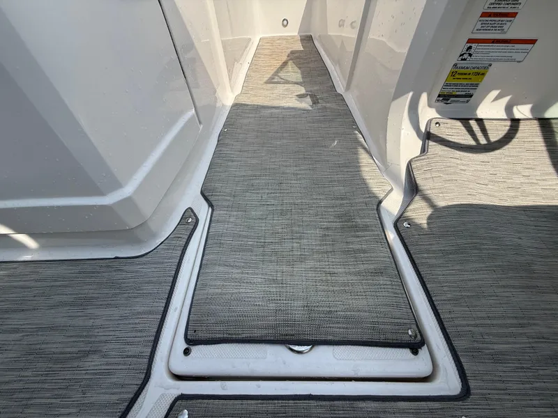 Slide: The Image of Interior view of 2017 Regal 22 FasDeck boat with gray carpet flooring. - 39