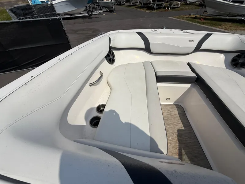 Slide: The Image of 2017 Regal 22 FasDeck boat interior with white seating and cup holders. - 44
