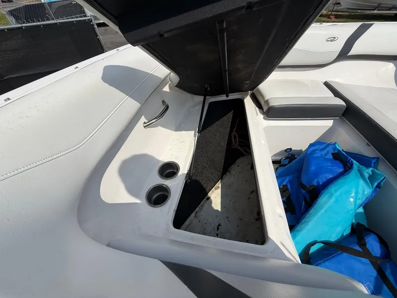 Slide: The Image of 2017 Regal 22 FasDeck boat interior with open storage compartment and blue bag. - 45