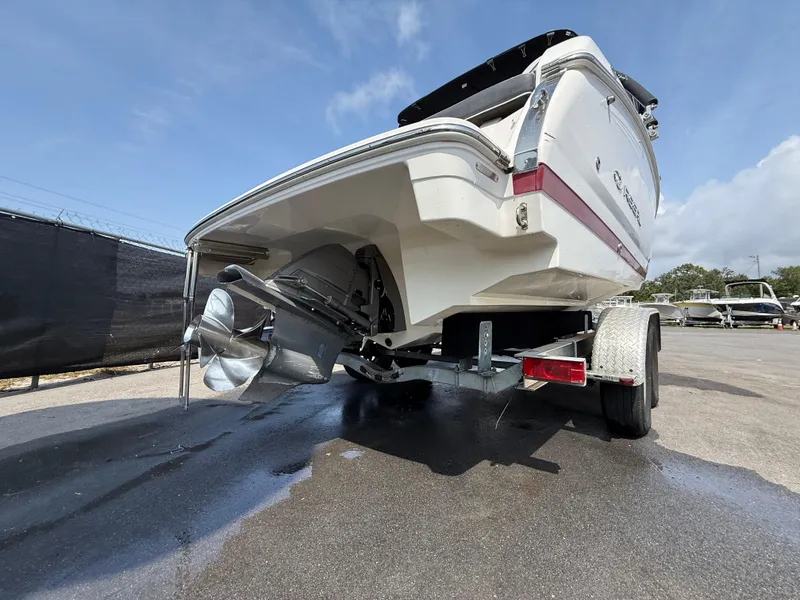 Slide: The Image of 2017 Regal 22 FasDeck boat on trailer, rear view, showcasing propeller and hull design. - 5