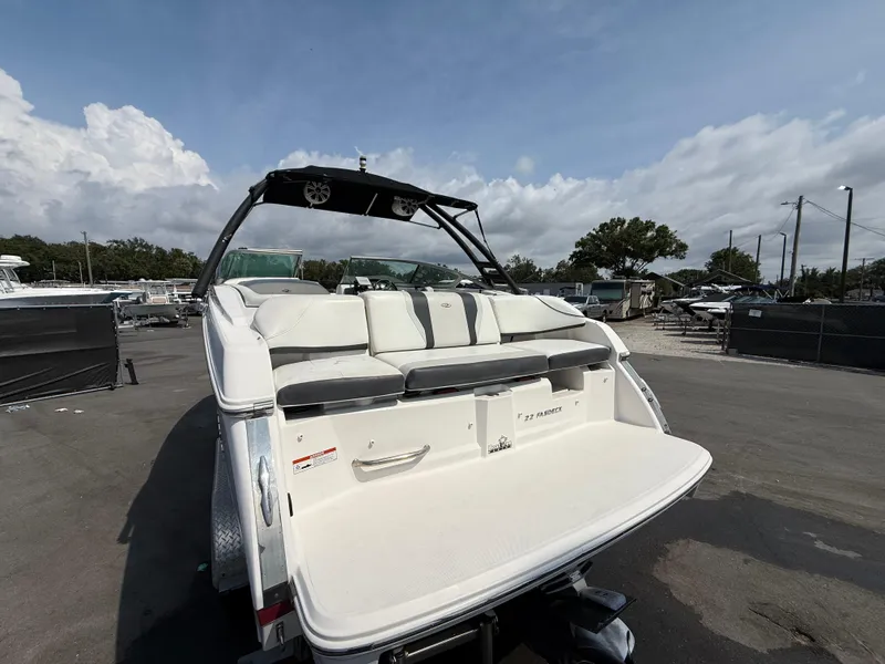 Slide: The Image of 2017 Regal 22 FasDeck boat, rear view, parked outdoors under a cloudy sky. - 9