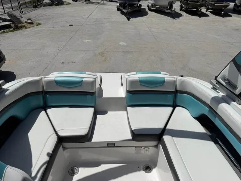 Slide: The Image of 2016 Chaparral VRX 203 boat interior with white and teal seating. - 11
