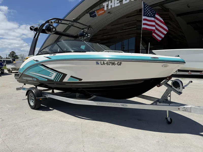 Slide: The Image of 2016 Chaparral VRX 203 boat on trailer, displayed outdoors with American flag. - 14