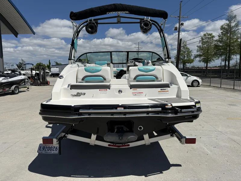 Slide: The Image of 2016 Chaparral VRX 203 boat, rear view, parked outdoors under a clear sky. - 15