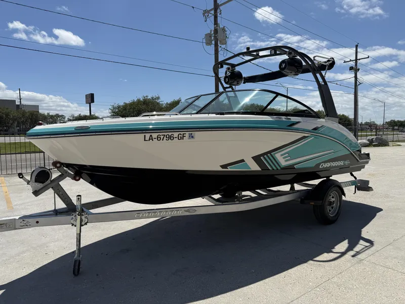 Slide: The Image of 2016 Chaparral VRX 203 boat on trailer, parked outdoors under a clear sky. - 16