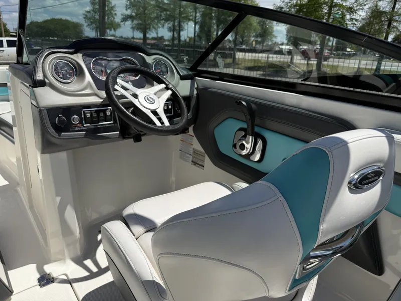 Slide: The Image of Interior view of 2016 Chaparral VRX 203 boat cockpit with steering wheel and controls. - 17