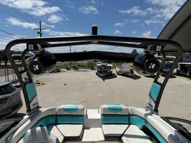 Slide: The Image of 2016 Chaparral VRX 203 boat interior with teal seating and mounted speakers. - 2