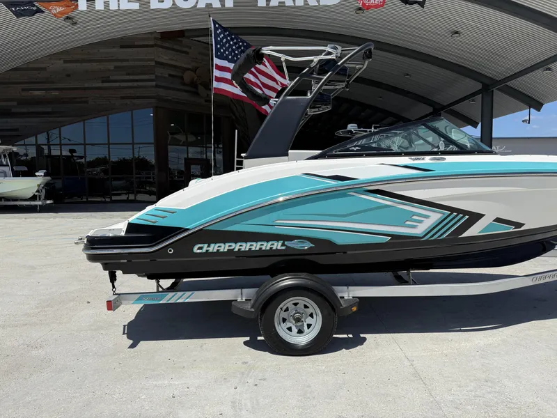 Slide: The Image of 2016 Chaparral VRX 203 boat with vibrant teal and black design on trailer. - 5