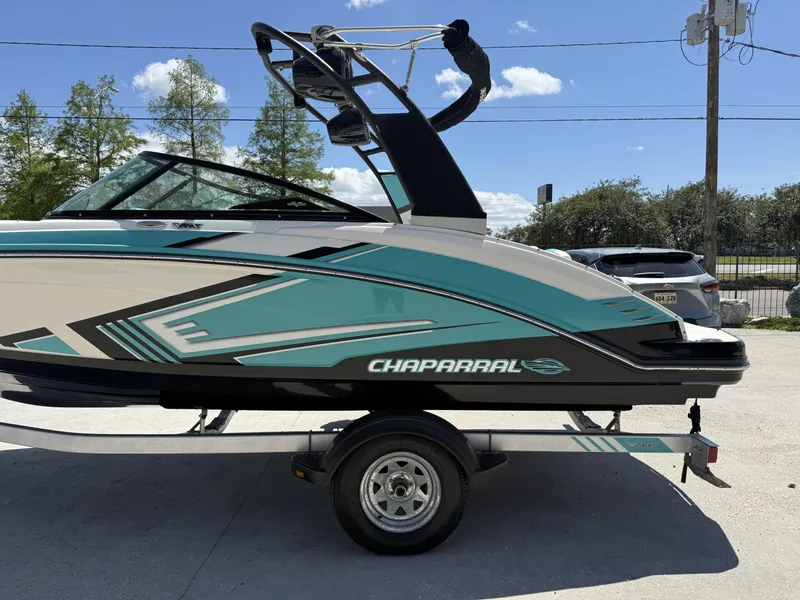 Slide: The Image of 2016 Chaparral VRX 203 boat on trailer, featuring sleek turquoise and black design. - 6