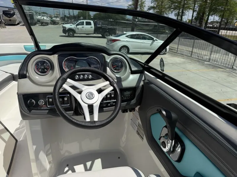 Slide: The Image of Interior view of 2016 Chaparral VRX 203 boat dashboard and steering wheel. - 8