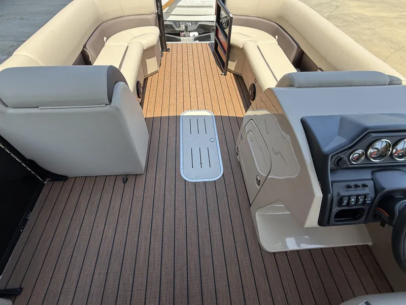 Slide: The Image of 2025 Bentley Pontoons Legacy 243 Swingback interior with luxurious seating and modern dashboard. - 11