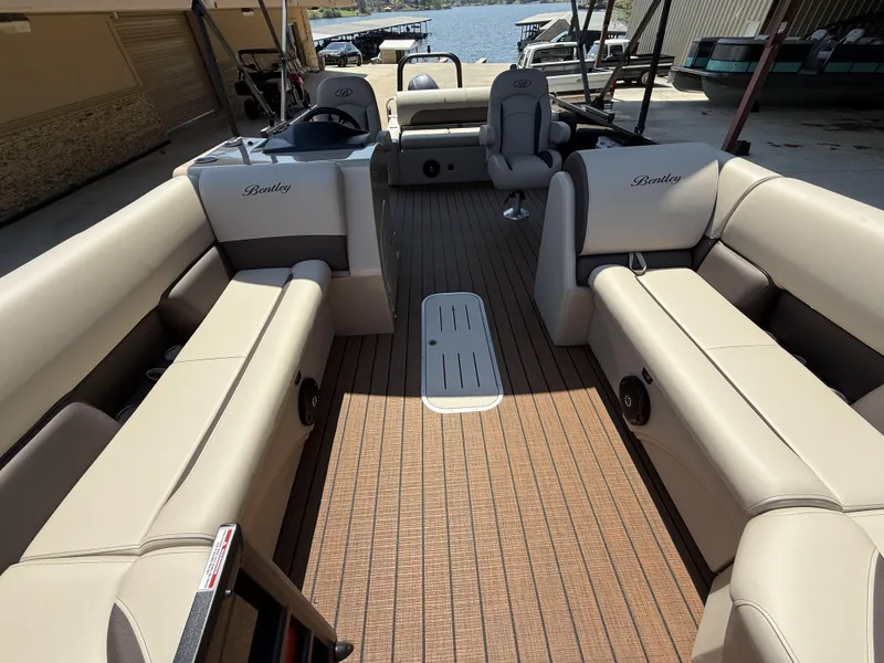 Slide: The Image of 2025 Bentley Pontoons Legacy 243 Swingback interior with beige seating and wood-style flooring. - 13