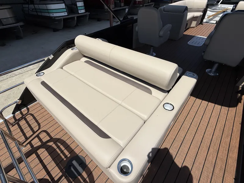Slide: The Image of 2025 Bentley Pontoons Legacy 243 Swingback 3/4 Tube with luxurious seating and wood-style flooring. - 4