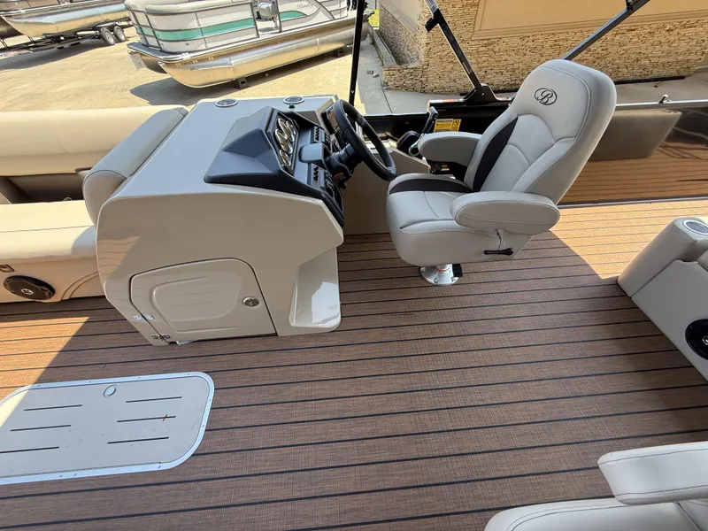 Slide: The Image of 2025 Bentley Pontoons Legacy 243 Swingback 3/4 Tube interior with captain's chair and console. - 7