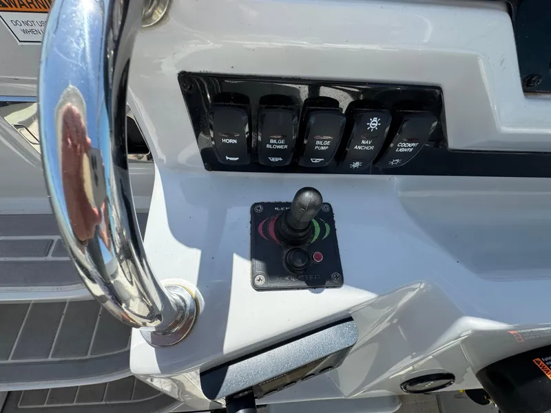 Slide: The Image of Control panel of a 2020 Regal 28 Express boat with switches and joystick. - 11