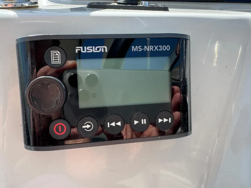 Slide: The Image of Fusion MS-NRX300 stereo control on 2020 Regal 28 Express boat dashboard. - 13