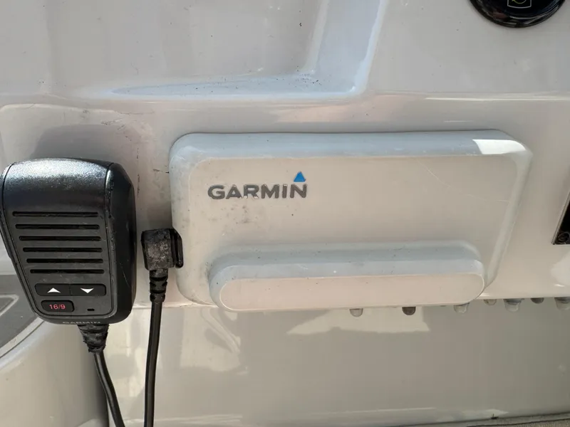 Slide: The Image of Garmin device and microphone on a 2020 Regal 28 Express boat dashboard. - 14