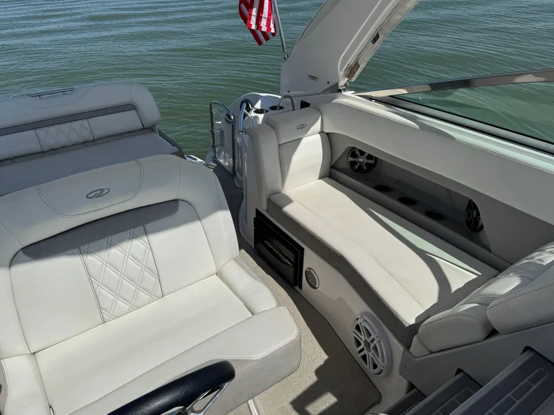 Slide: The Image of 2020 Regal 28 Express boat interior with white seating and American flag. - 18