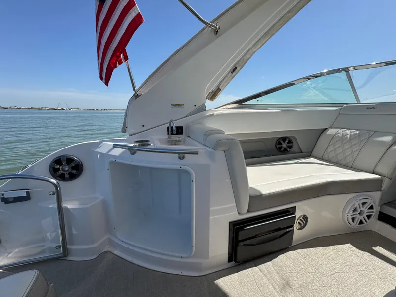 Slide: The Image of 2020 Regal 28 Express boat interior with seating and American flag. - 20