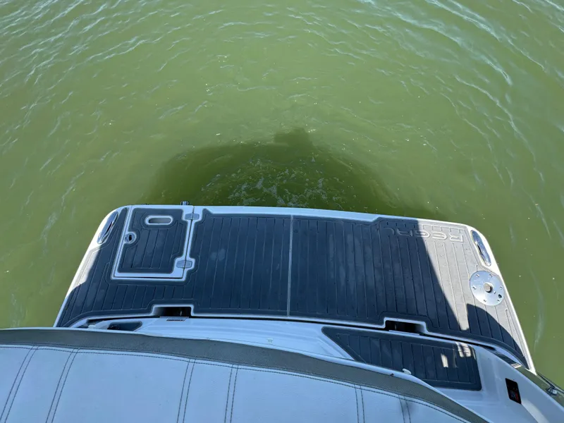 Slide: The Image of 2020 Regal 28 Express boat deck over green water. - 23