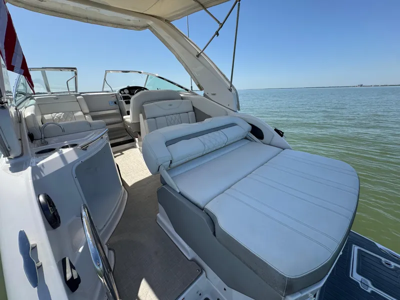 Slide: The Image of 2020 Regal 28 Express boat interior with spacious seating, overlooking calm waters. - 25