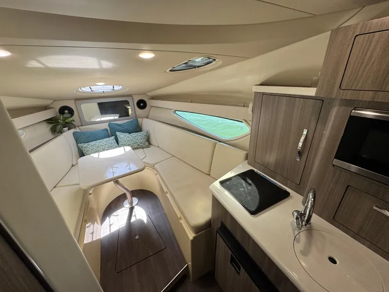 Slide: The Image of 2020 Regal 28 Express cabin interior with seating, kitchenette, and modern amenities. - 29