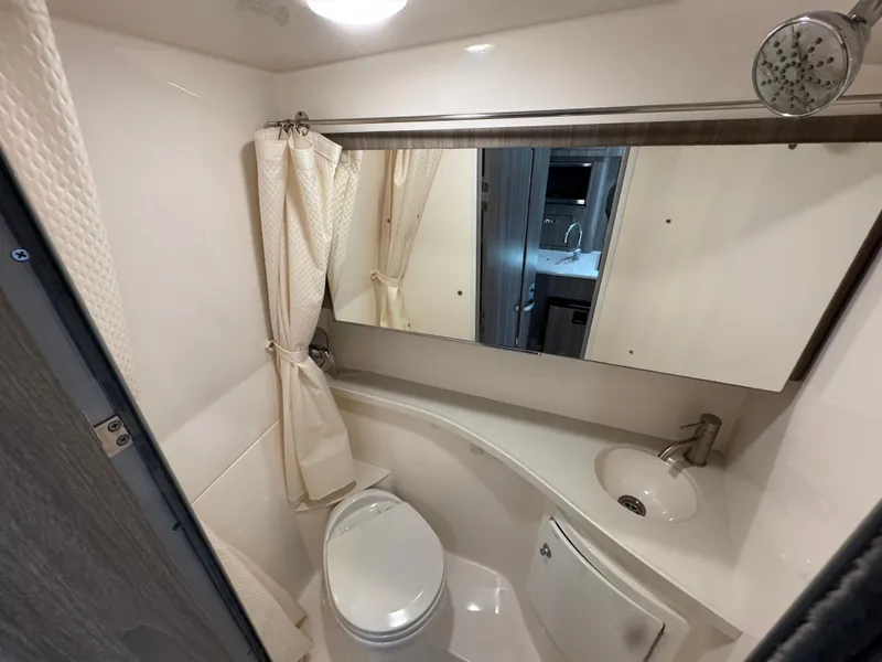 Slide: The Image of 2020 Regal 28 Express boat bathroom with shower, toilet, and sink. - 34
