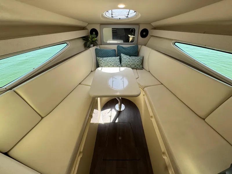 Slide: The Image of 2020 Regal 28 Express cabin interior with beige seating and a central table. - 35