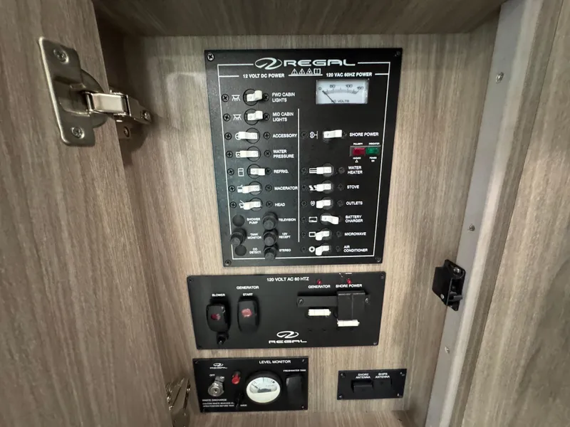 Slide: The Image of Electrical control panel inside a 2020 Regal 28 Express boat, featuring various switches and gauges. - 37