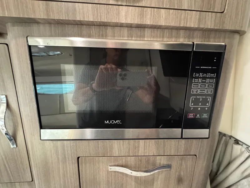Slide: The Image of Microwave oven in 2020 Regal 28 Express boat interior, wood cabinetry. - 38