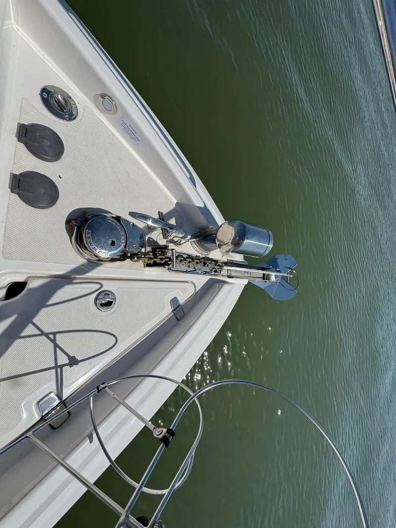 Slide: The Image of 2020 Regal 28 Express boat bow with anchor and calm water view. - 5