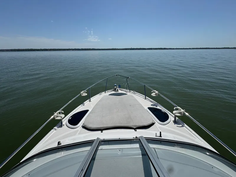 Slide: The Image of 2020 Regal 28 Express boat on calm water under clear blue sky. - 7