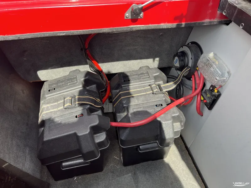 Slide: The Image of 2008 Calabria PRO V boat battery compartment with dual batteries and red cables. - 15