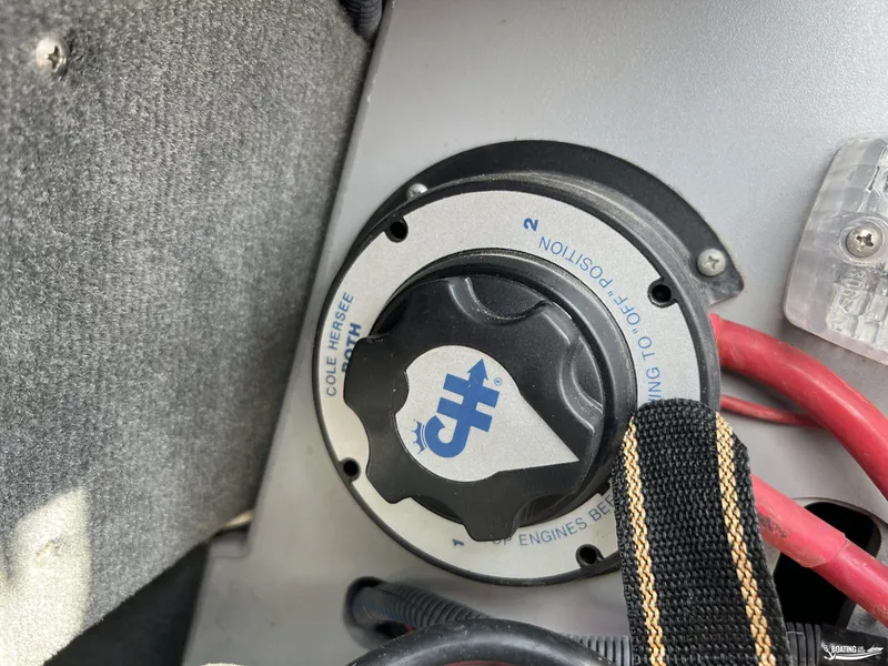 Slide: The Image of 2008 Calabria PRO V battery switch with red cables and black strap. - 16