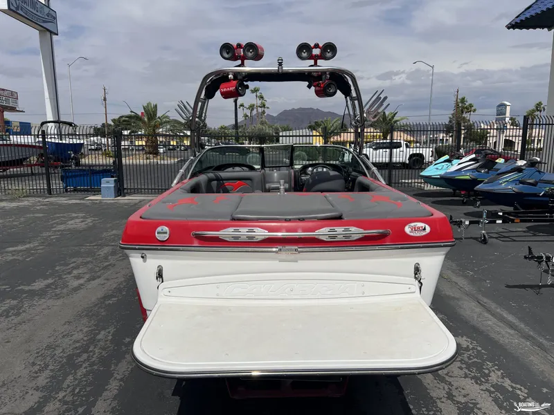 Slide: The Image of 2008 Calabria PRO V boat with red and white design, parked outdoors. - 3