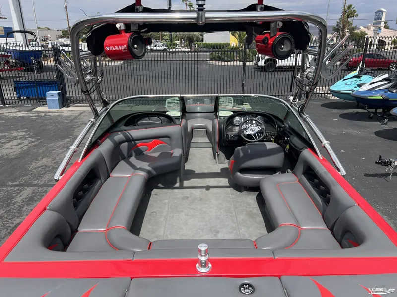 Slide: The Image of 2008 Calabria PRO V boat interior with gray and red seating, steering wheel, and tower speakers. - 4