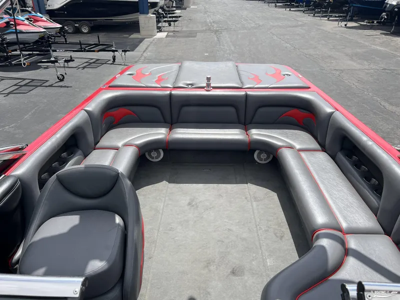 Slide: The Image of 2008 Calabria PRO V boat interior with gray and red seating, cup holders, and flame design. - 6