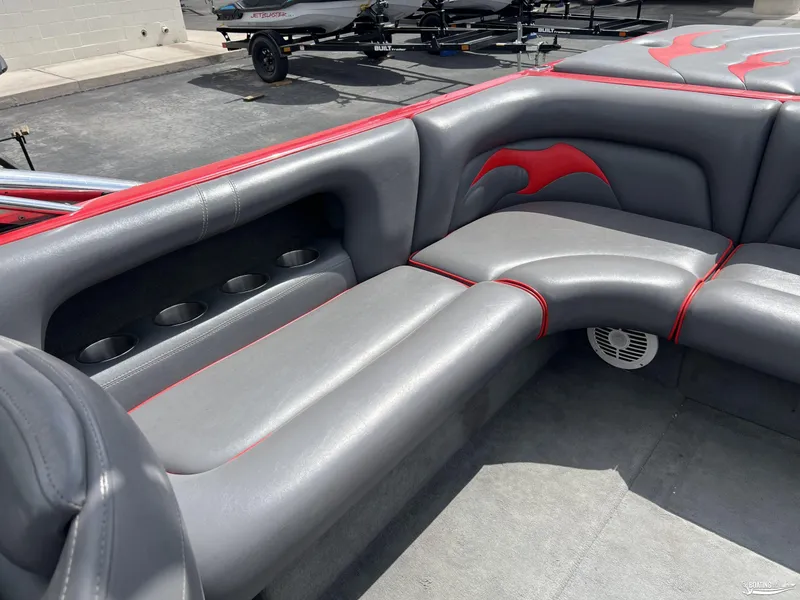 Slide: The Image of 2008 Calabria PRO V boat interior with gray and red seating, cup holders, and speaker. - 7