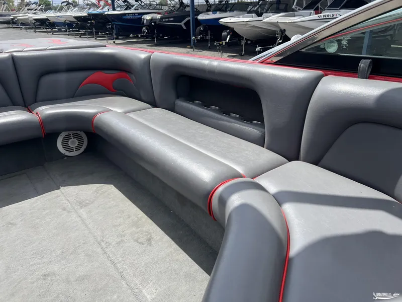 Slide: The Image of 2008 Calabria PRO V boat interior with gray and red seating, docked among other boats. - 9