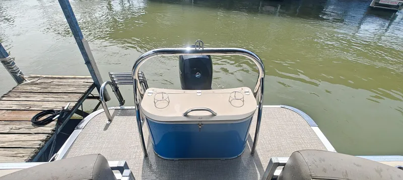 Slide: The Image of 2023 Avalon LSZ ENTERTAINER pontoon boat with rear deck and cooler, docked by the water. - 5