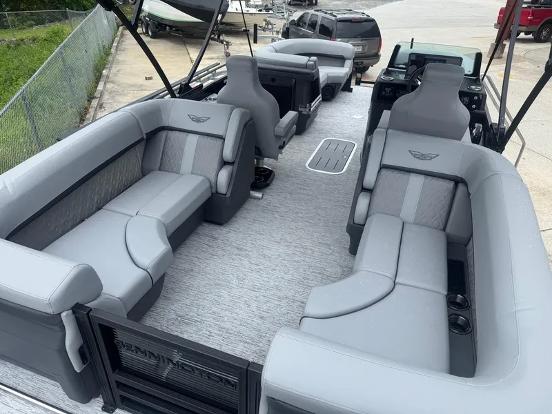 Slide: The Image of 2025 Bennington 22MFB pontoon boat with spacious gray seating and modern design. - 10